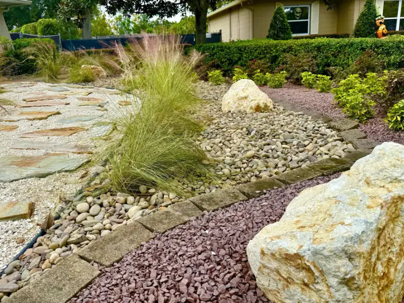 Dry creek bed and planted landscape installed by DeAngelo’s Land Services