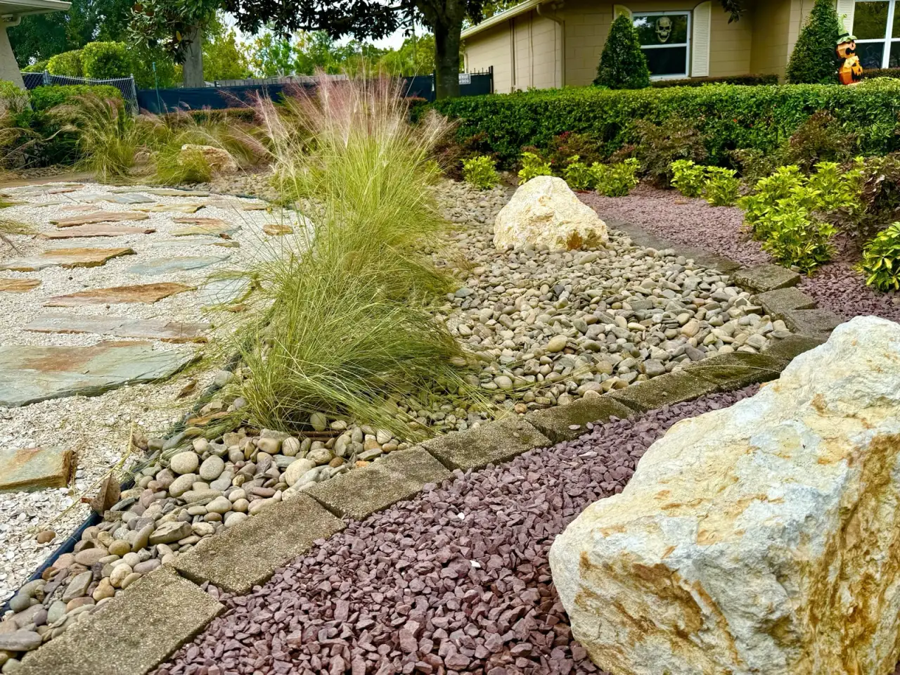Dry creek bed and planted landscape installed by DeAngelo’s Land Services