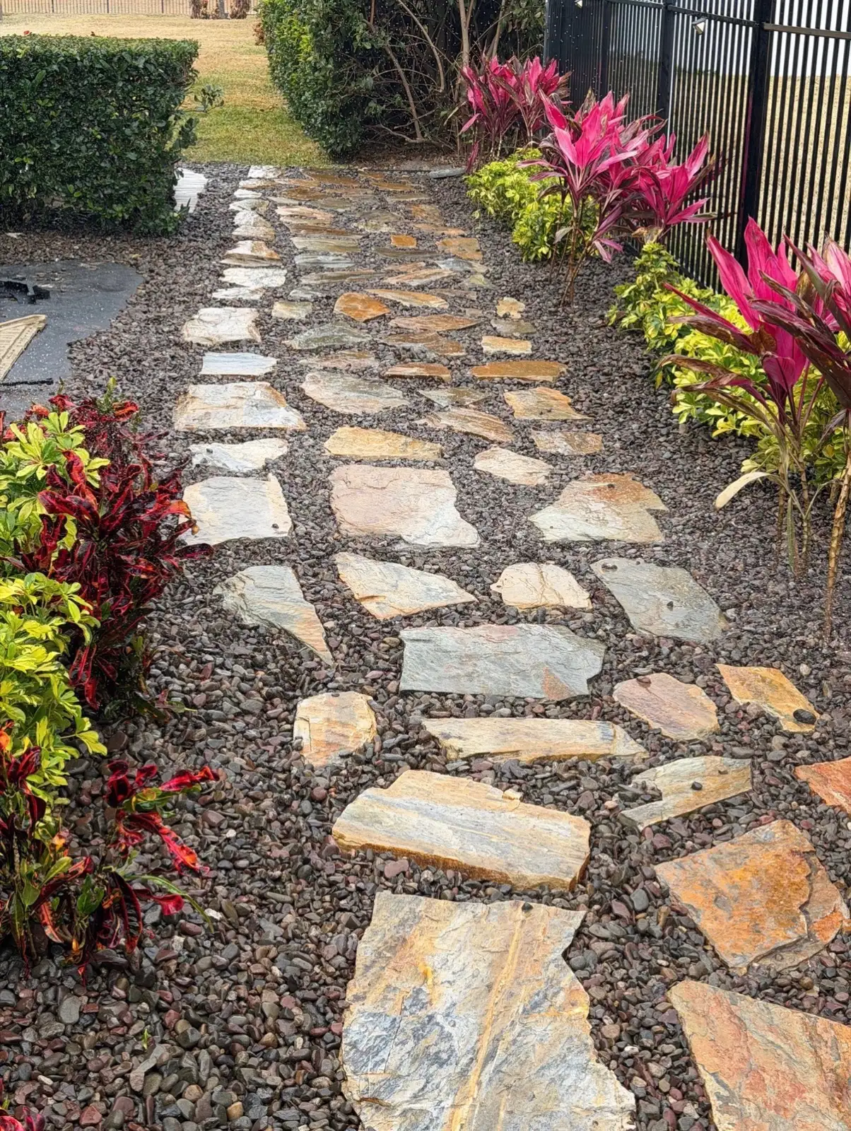 Flagstone path with crotons installed by DeAngelo’s Land Services