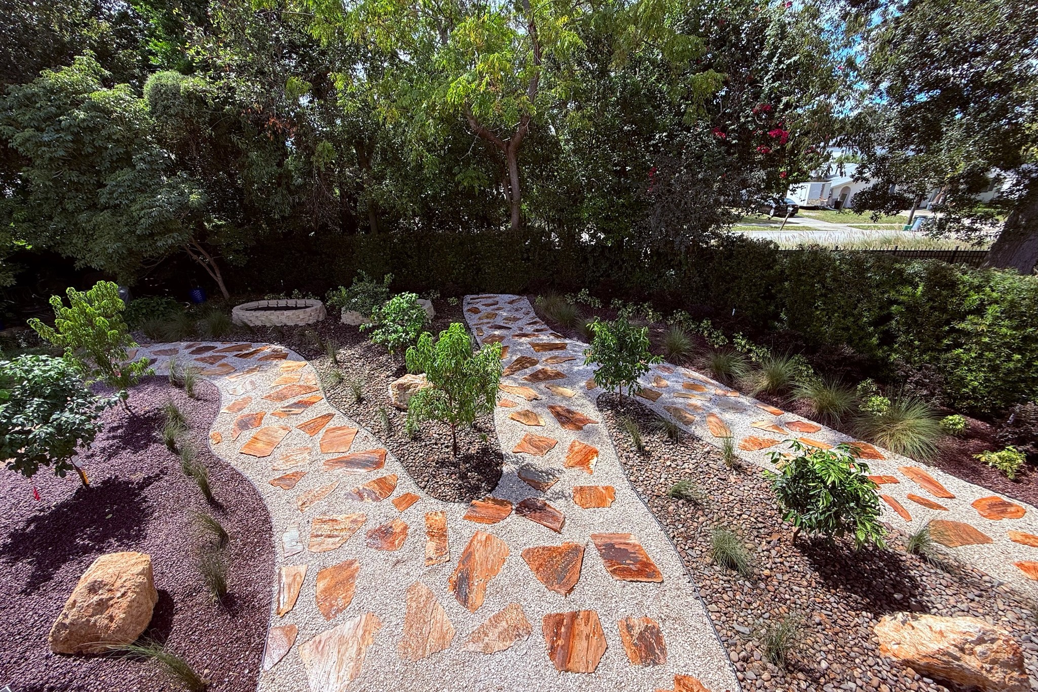 Custom orange flagstone walkway with river rock and fresh plantings — landscape design and build by DeAngelo's Land Services near Lake Mary, FL