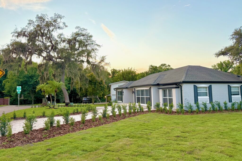 Freshly installed sod lawn with new hedge-row plantings at a Central Florida home — sod installation by DeAngelo's Land Services